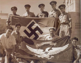 These flags are flags of the Nazi Youth Organization "Hitler-Jugend", regional branch of Palestine. The historical context to the Grand Mufti of Jerusalem, Haj Amin Al-Husseini."