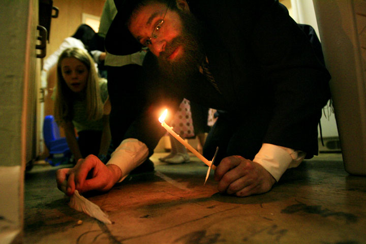 Rabbi Chaim Lazaroff, searches for leavened bread, also called chametz, at Chabad of Uptown April 17, 2008 in Houston. The candle is used to search for the chametz, while a feather is used to sweep it in to a wooden spoon. All three items are burned along with the chametz. The burning of leavened bread represents the eradication of the ego and all of the negative energies associated with the ego according to Jewish religious scripture. Pesach, or Passover, celebrates freedom. Egypt represents the limitation of ourselves. The observance of Passover is an exercise in being better today than we were yesterday and unleashing personal boundaries to drive ourselves to perfection. Thursday, April 17, 2008, in HOUSTON. ( Eric Kayne / Chronicle )