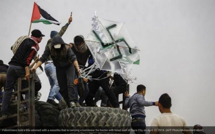 Gaza “protesters” loft molotov cocktail on swastika kite over Israeli border