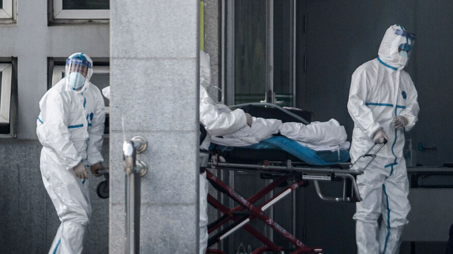 hospital workers in protective suits with infected citizens