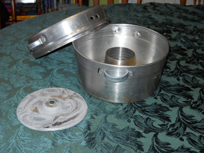 The Wonder Pot: bottom flame heat diffuser, the Pot and top cover with holes to let the heat out.