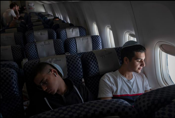 Brothers Gabriel and Netanel Zeitoun rest on their flight from Paris to Tel Aviv.