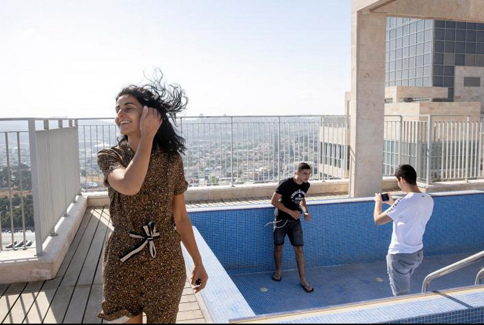 On their first day in Jersulem, Yael, Gabriel, and Netanel Zeitoun explore the rooftop of their new apartment building.