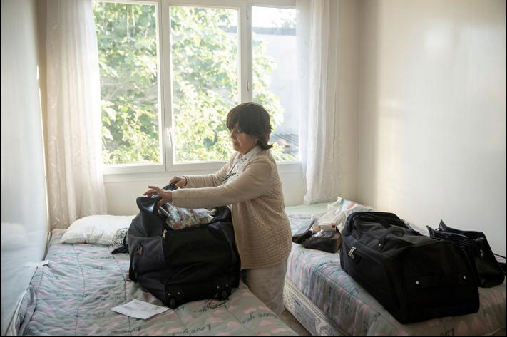 Esther Elfersi finishes packing her bags for the journey the next morning.