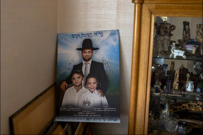 A memorial poster of Jonathan and his sons is displayed in Sandler's home in the Paris suburb of Le Chesnay.