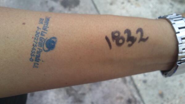 Numbers and government stamps on arms. People is marked like this in Venezuela to be able to buy food