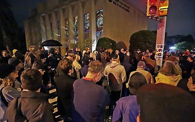 A group gathers outside the Tree of Life Synagogue for a vigil to honor the victims of the Saturday attack on a synagogue in California, Saturday, April 27, 2019, in the Squirrel Hill neighborhood of Pittsburgh. (AP Photo/Gene J. Puskar)