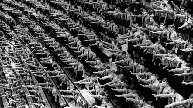 An Associated Press photograph shows some of over 132,000 members of the Hitler youth organisation assembled at the Olympic Stadium in Berlin, where German Chancellor Adolf Hitler and Dr. Joseph Goebbels addressed them, as part of the usual round of May Day festivities and demonstrations in Germany on May 1, 1939. The AP caption notes: 'The Fuhrer arrives and the members of the Hitler youth organisation rise as one man to give the Nazi salute at the demonstration in the Olympic Stadium, Berlin.' (AP Photo)