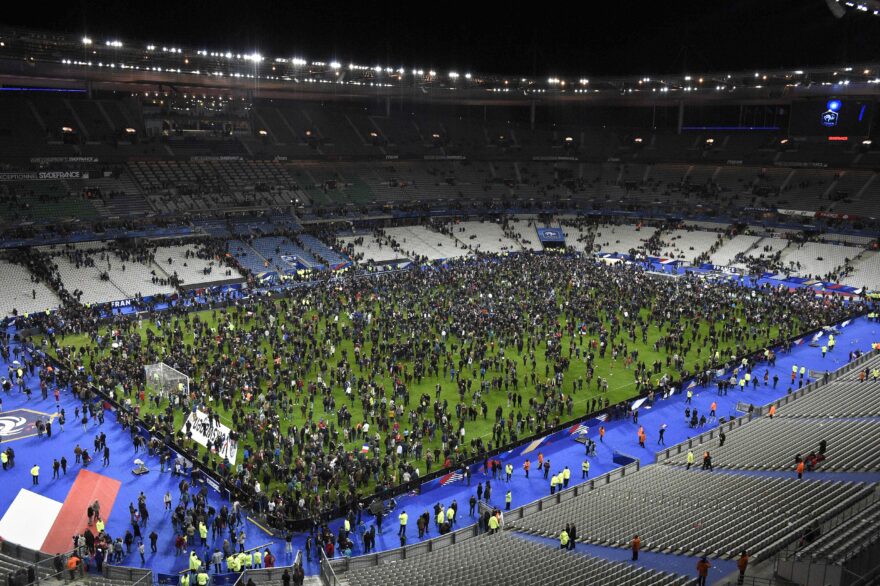 Spectators gather on the pitch of the Stade de France stadium following the friendly football match between France and Germany in Saint-Denis, north of Paris, on November 13, 2015, after a series of gun attacks occurred across Paris as well as explosions outside the national stadium where France was hosting Germany. At least 18 people were killed, with at least 15 people had been killed at the Bataclan concert hall in central Paris, only around 200 metres from the former offices of Charlie Hebdo which were attacked by jihadists in January. AFP PHOTO / FRANCK FIFE (Photo credit should read FRANCK FIFE/AFP/Getty Images)