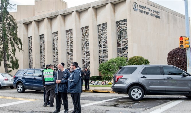 A Jewish emergency crew and police officers at the site of the mass shooting that killed 11 people and wounded 6, including 4 police, at the Tree of Life Synagogue on October 28, 2018, in Pittsburgh, Pennsylvania. (Jeff Swensen/Getty Images/via JTA)