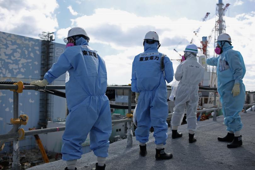 Workers stand near the deserted nuclear power plant in Fukushima, Japan, Feb. 25, 2016. (Photo: Getty Images)