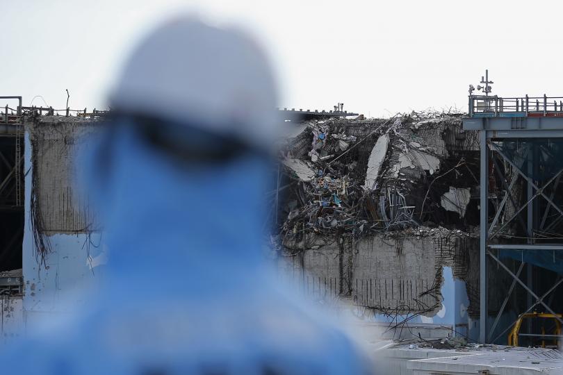 A TEPCO employee looks at the destroyed reactor in Fukushima, Japan, Feb. 25, 2016. (Photo: Getty Images)