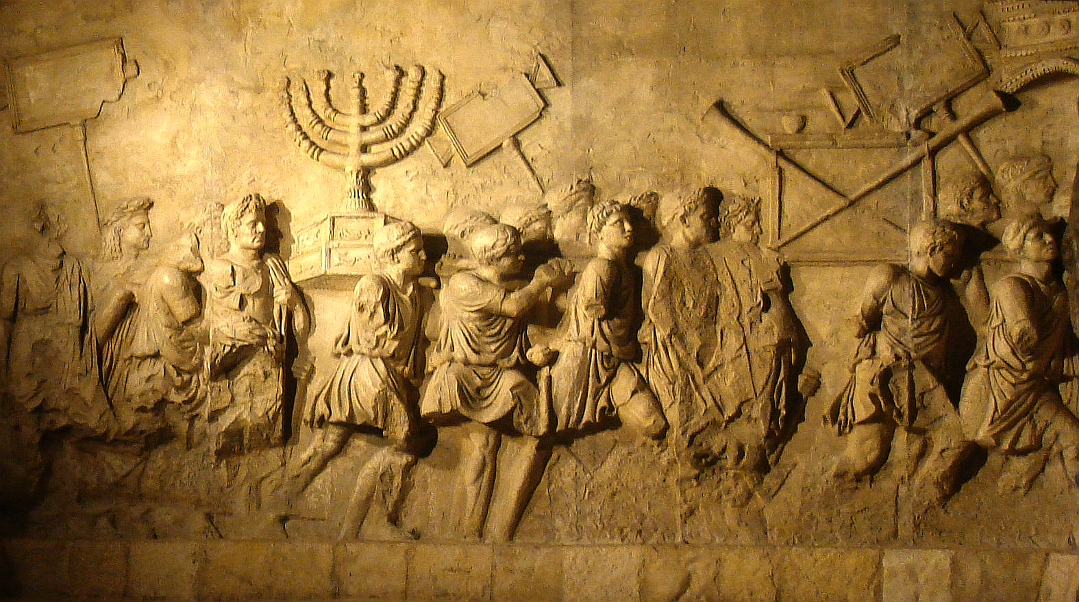 The Arch of Titus is a 1st-century AD honorific arch. The arch contains panels depicting the triumphal procession celebrated in 71 AD after the Roman victory culminating in the fall of Jerusalem. It became a symbol of the Jewish Diaspora,