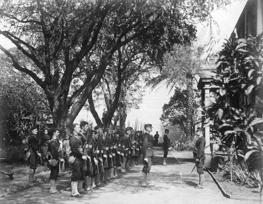 The USS Boston's landing force on duty at the Arlington Hotel, Honolulu, at the time of the overthrow of the Hawaiian monarchy, January 1893. Lieutenant Lucien Young, USN, commanded the detachment, and is presumably the officer at right.