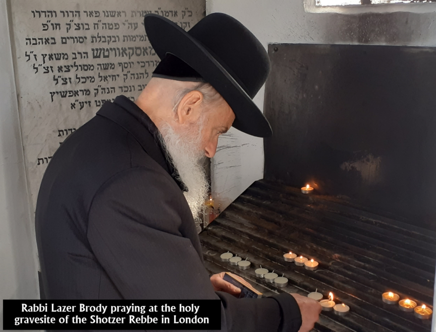 Rabbi Lazer Brody praying at the holy gravesite of the Shotzer Rebbe in London