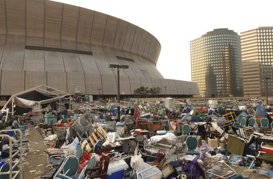 The Louisiana Superdome stands littered and deserted, except for some police, military and an occasional stray dog, Saturday, Sept. 3, 2005, after Hurricane Katrina refugees staying at the Superdome evacuated New Orleans. (AP Photo/The Times, Greg Pearson)