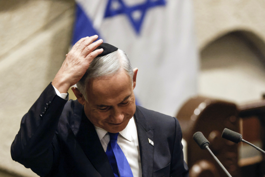 Israeli Prime Minister-designate Benjamin Netanyahu adjusts his kippah after speaking at a special session of the Knesset, Israel's parliament, to approve and swear in a new government, in Jerusalem on December 29, 2022. Photo: Pool / Amir Cohen