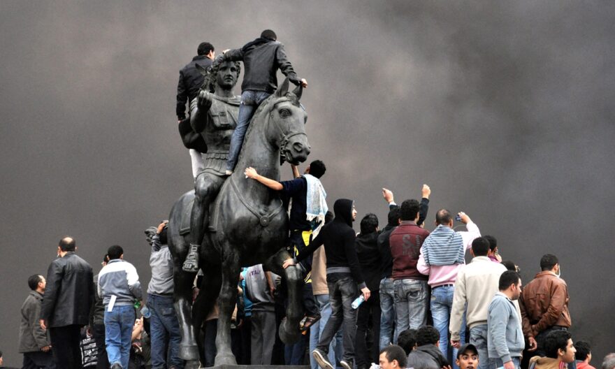Egyptian protesters gather on the statue of Alexander the Great in Alexandria on January 28, 2011. Photo AFP