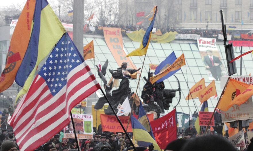 Supporters of US-backed Ukrainian opposition leader wave flags during a rally in Kiev, November 28, 2004. Photo: AFP