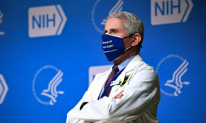 Former Director of the National Institute of Allergy and Infectious Diseases (NIAID) Dr. Anthony Fauci listens to President Joe Biden (out of frame) speak during a visit to the National Institutes of Health (NIH) in Bethesda, Md., on Feb. 11, 2021. (Saul Loeb/AFP via Getty Images)