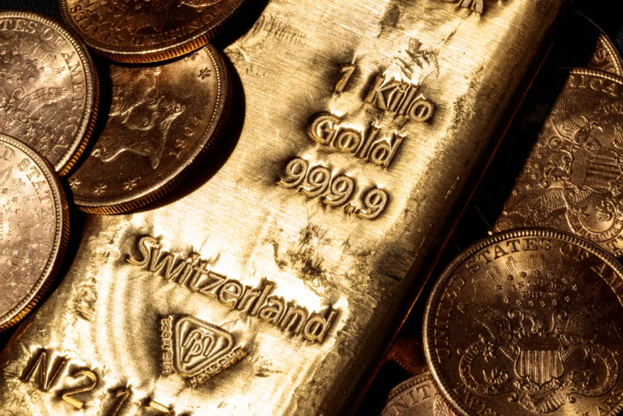 A one-kilo Swiss gold bar and gold U.S. dollars coins in Paris on Feb. 20, 2020. (JOEL SAGET/AFP via Getty Images)