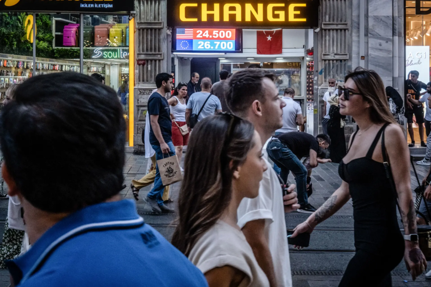 People walk past a currency exchange shop in Istanbul, Turkey, on June 23, 2023. (Chris McGrath/Getty Images)