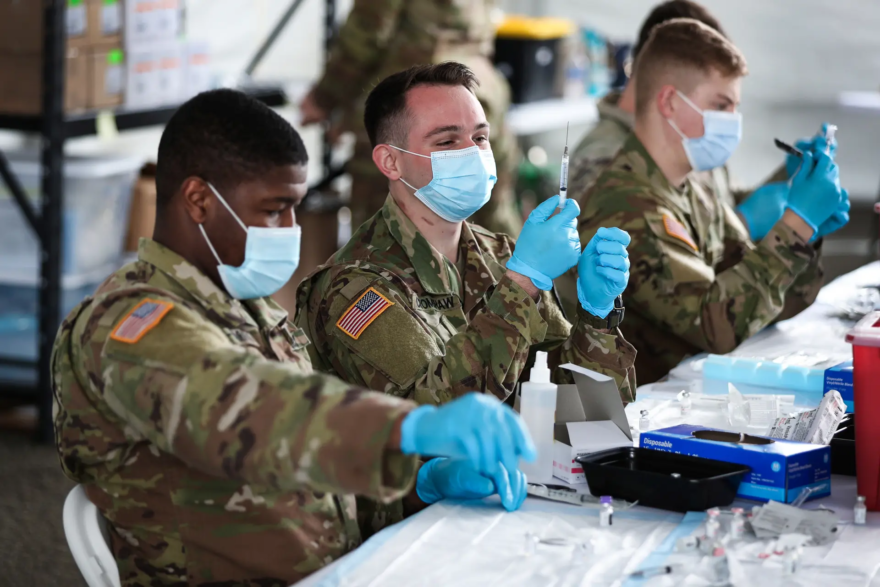 U.S. Army soldiers prepare Pfizer COVID-19 vaccines at the Miami Dade College North Campus in North Miami on March 9, 2021. (Joe Raedle/Getty Images