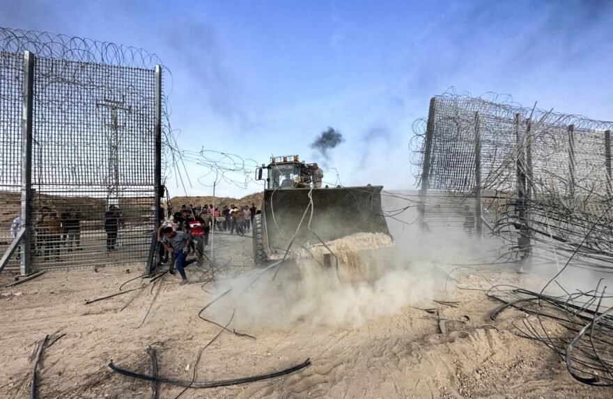 Hamas troops break down the Gaza border fence on October 7, allowing Gazans to cross into Israel. Photo credit: REUTERS.