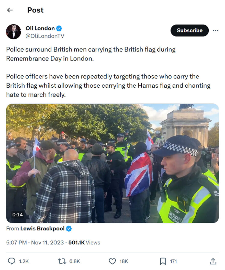 Oli London-tweet-11November2023-Police surround British men carrying the British flag