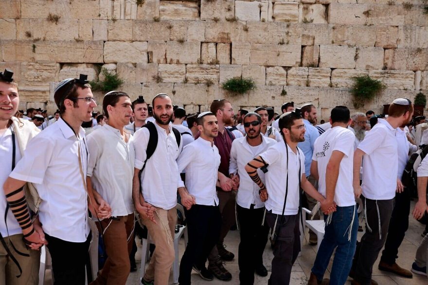 Jewish men gather at the Western Wall, the holiest site where Jews are allowed to pray, in the Old City of Jerusalem on May 10, 2021, as Israel marks “Jerusalem Day.” Photo by MENAHEM KAHANA/AFP via Getty Images.