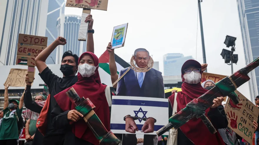 Anti-Israel demonstrators carry a cutout depicting Israeli Prime Minister Benjamin Netanyahu alongside mock cardboard weapons and placards during a rally Oct. 9, 2026 in Kuala Lumpur, Malaysia. (Annice Lyn/Getty Images)